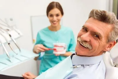 patient smiling in the dental chair during his visit to Southard Family Dentistry