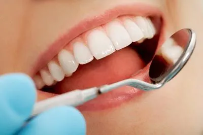 closeup of a dentist taking a look at a patient's teeth